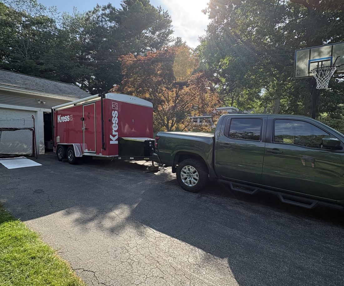 A pickup towing the red Kress trailer